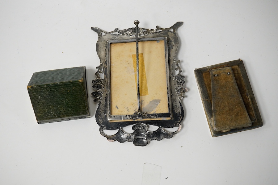 A Chinese Export engraved and embossed white metal photograph frame, maker KW, 14.5cm, together with two small Edwardian silver mounted photograph frames. Condition - fair to good